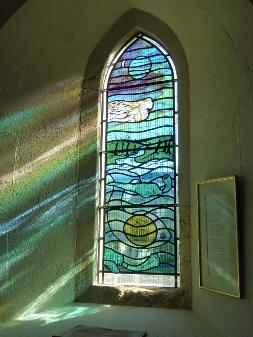 Modern stained glass window in Earnley Church. 